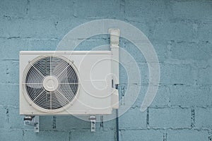 Condenser air conditioner with vintage brick background