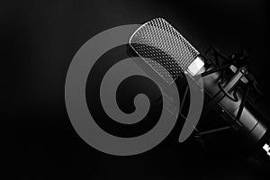 Condenser black studio microphone on a black background. Streamer, podcasts, music background