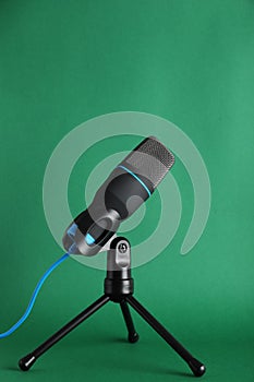 Condenser microphone on color background.