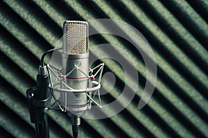 Condenser microphone on foam background, studio recording equipment