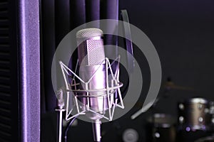 Condenser microphone in modern recording studio.