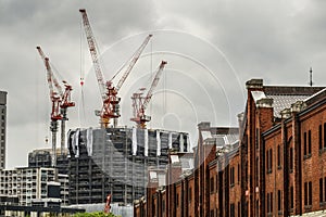 Condominiums and red brick warehouse under construction