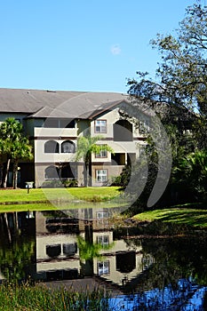 Condos or apartments and a small pond