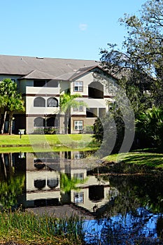 Condos or apartments and a small pond