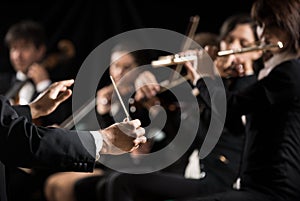 Conductor directing symphony orchestra photo