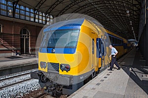 Conductor getting in a train ready to start in The Hague, the Netherlands