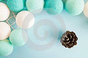 Cone on the blue background with blue and white lights made of yarn threads, top view.