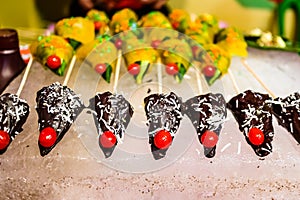 Cone of chocolate flavored betel leaf on ice stuffed with cherry known as mango paan with selective focus and blurred