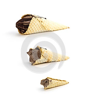 A cone with chocolate ice cream. Whole and bitten ice cream. Isolated on a white background