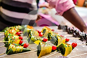 Cone of mango flavored betel leaf stuffed with cherry known as mango paan.