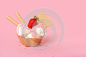 cone with scoops of ice cream strewed sprinkles, poured with glaze and decorated strawberries on pink background