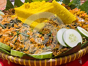 Cone-shaped yellow rice is an Indonesian traditional food, called Nasi Tumpeng.