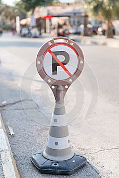 cone warning about a parking ban of automobile and cars. traffic safety sign on city street road. danger warning symbol on urban w