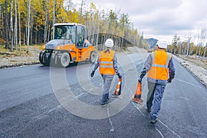 Cone worker asphalting