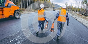 Cone worker asphalting