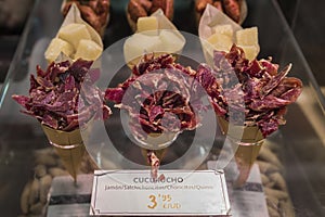 Cones or cucurucho of iberico ham, sausage and cheese at butcher, Pamplona Spain photo