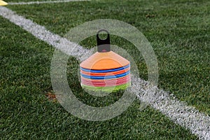 Cones in football field. Coath arranged colorful markers in trainning grassfield of football soccer stadium