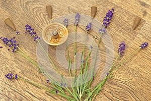 Cones incense and lavender flowers on a wooden table
