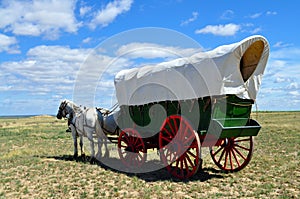 A conestoga wagon pulled by team of horses