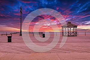 Coney Island beach with Pavilion and Boardwalk during sunset