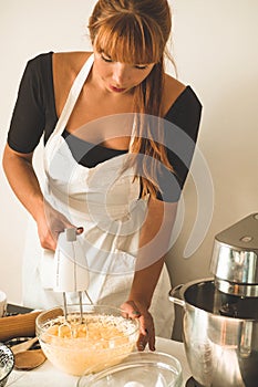 Confectioner girl is preparing a cake. Concept ingredients for cooking flour products or dessert