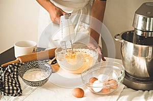 Confectioner girl is preparing a cake. Concept ingredients for cooking flour products or dessert