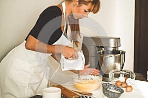 Confectioner girl is preparing a cake. Concept ingredients for cooking flour products or dessert