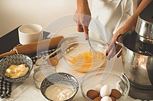 Confectioner girl is preparing a cake. Concept ingredients for cooking flour products or dessert