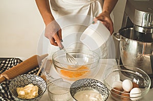 Confectioner girl is preparing a cake. Concept ingredients for cooking flour products or dessert