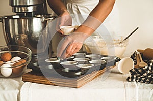 Confectioner girl is preparing a cupcake. Concept ingredients for cooking flour products or dessert