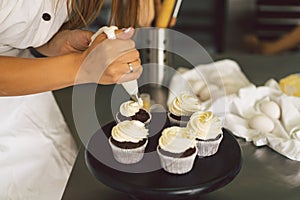Confectioner girl is preparing a cupcakes. Concept ingredients for cooking flour products or dessert