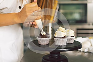 Confectioner girl is preparing a cupcakes. Concept ingredients for cooking flour products or dessert