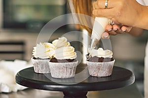 Confectioner girl is preparing a cupcakes. Concept ingredients for cooking flour products or dessert