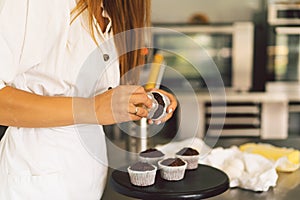 Confectioner girl is preparing a cupcakes. Concept ingredients for cooking flour products or dessert