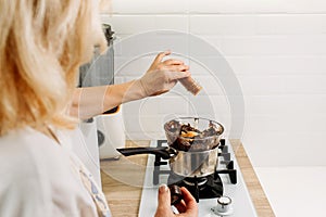 The confectioner pours dry ground paprika into the melted chocolate