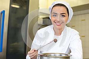 Confectioner producing filled chocolates photo