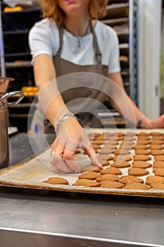 Confectioner working, take out the tea dough, cookies from the oven tray photo