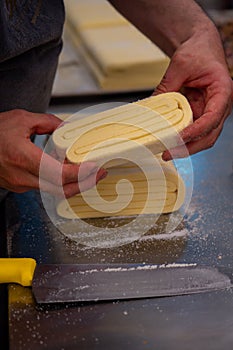 Confectioner works the puff pastry dough, artisan, gourmet photo