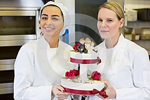Confectioners or bakers presenting wedding cake