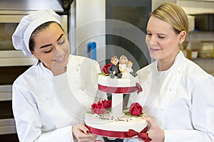 Confectioners or bakers presenting wedding cake