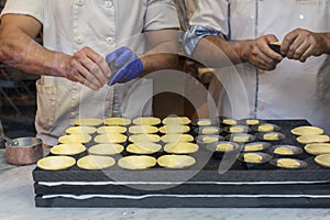 Confectioners makin the famous Portuguese cake Pastel de nata