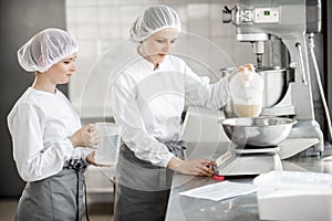 Confectioners working at the bakery manufacturing