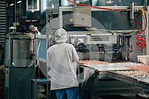 Confectioners works on marshmallow production line