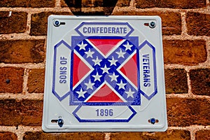 Confederate flag plaque attached to brick wall