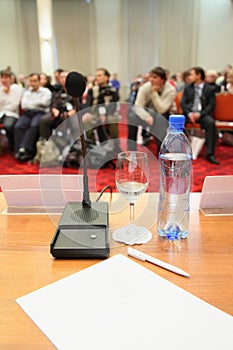 Conference in hall. focus on bottle.