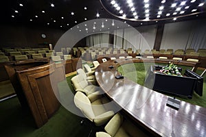 Conference hall with table and rows of chairs