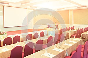 Conference Meeting Room , Row of  Chairs with Stage and Empty Screen for Business Meeting, Conference, Training Course, used as