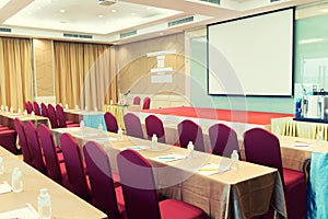 Conference Meeting Room , Row of  Chairs with Stage and Empty Screen for Business Meeting, Conference, Training Course, used as