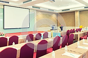 Conference Meeting Room , Row of  Chairs with Stage and Empty Screen for Business Meeting, Conference, Training Course, used as