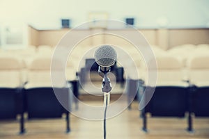 Before a conference, the microphones in front of empty chairs.